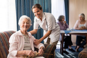 caregiver assisting senior citizen with medication