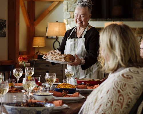 elderly woman holding a turkey platter for Thanksgiving