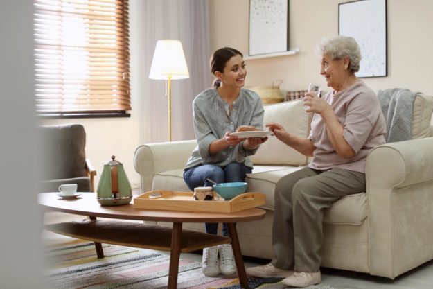 What is an Assisted Living Facility woman and friend on couch discuss what is an assisted living facility