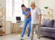 Senior citizen in assisted living facility recieving assistance from a staff member