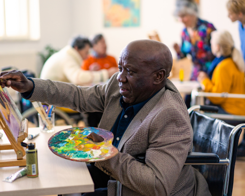 Summer’s Landing (3) Senior Citizen painting a picture