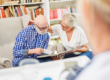 Two Seniors reading a book together