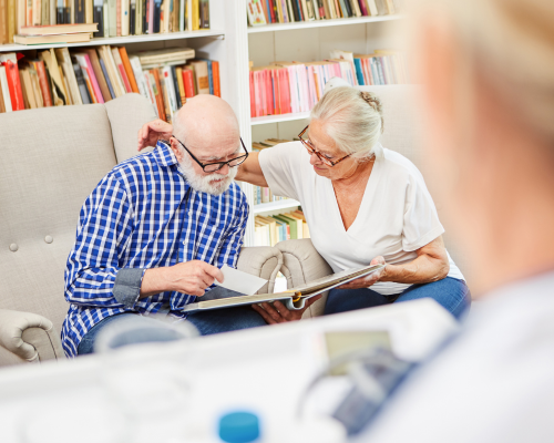 Two Seniors reading a book together
