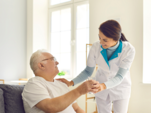 caregiver assisting senior citizen with medication