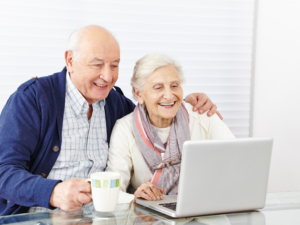 Senior citizens browsing on a laptop together